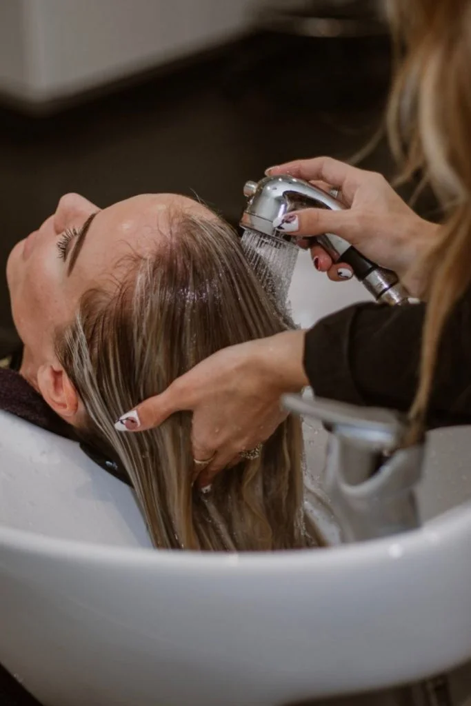 Hair being rinsed at a salon basin